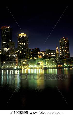 Stock Photography -  Boston, skyline, MA, Massachusetts, The lights of the downtown skyline of Boston reflect in the calm waters of the Boston Harbor at night. . Fotosearch