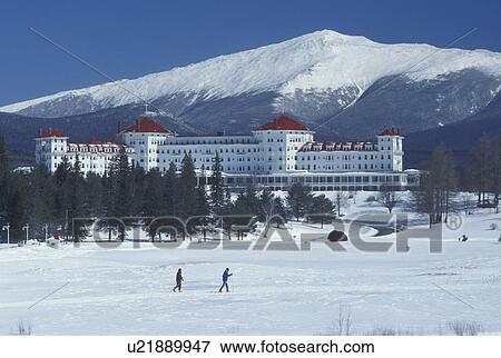 Bretton Woods, NH, New Hampshire, Scenic view of Historic Mount Washington Hotel & Resort and Mt. Washington in winter in the White Mountains National Forest. People cross-country skiing in front of the resort. View Large Photo Image Stock Photo - Bretton Woods, NH, New Hampshire, Scenic view of Historic Mount Washington Hotel & Resort and Mt. Washington in winter in the White Mountains National Forest. People cross-country skiing in front of the resort.. Fotosearch