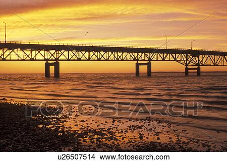 bridge, Mackinaw City, MI, Michigan, Upper Peninsula, View of Mackinac Bridge, a suspension span bridge, at sunset crosses the Straits of Mackinaw in Mackinaw City connecting the Lower Peninsula with the Upper Peninsula of Michigan. View Large Photo Image Picture - bridge, Mackinaw City, MI, Michigan, Upper Peninsula, View of Mackinac Bridge, a suspension span bridge, at sunset crosses the Straits of Mackinaw in Mackinaw City connecting the Lower Peninsula with the Upper Peninsula of Michigan.. Fotosearch
