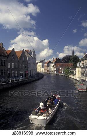 Brugge, Belgium, Bruges, West-Vlaanderen, Europe, A cruise boat takes passengers along the canal in Bruges. View Large Photo Image Stock Photo - Brugge, Belgium, Bruges, West-Vlaanderen, Europe, A cruise boat takes passengers along the canal in Bruges.. Fotosearch
