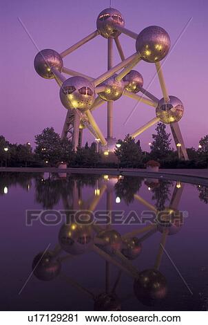 Stock Image -  Brussels, Bruxelles, Belgium, Europe, Reflection of The Atomium, symbol of the 1958 World's Fair, a monument composed of nine giant metal spheres that represent the atoms of an iron molecule, in the water in the evening.. Fotosearch