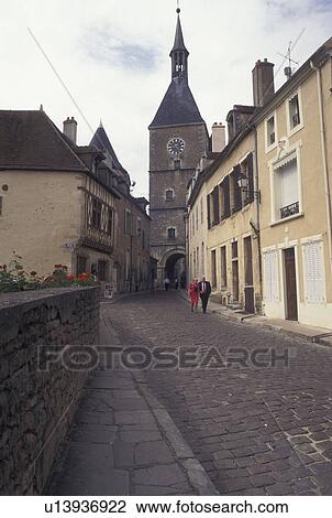 Stock Image -  Burgundy, France, Avallon, Yonne, wine region, Bourgogne, Europe, View of Tour de l' Horloge on a narrow cobbled street in the medieval village of Avallon in the wine region of Burgundy.. Fotosearch