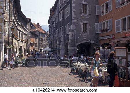 Picture -  cafT, France, Annecy, Haute-Savoie, Rhone-Alpes, Europe, Shops and outdoor cafes along a narrow pedestrian street in the old town of Annecy. . Fotosearch