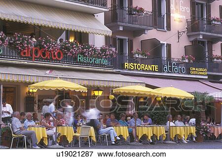 Stock Photo -  cafT, Switzerland, Ticino, Ascona, Lake Maggiore, Outdoor cafTs along the lakefront in the city of Ascona at night.. Fotosearch