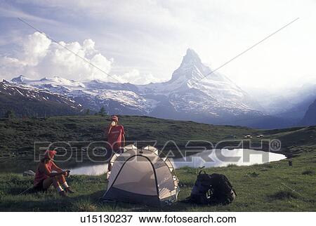 camping, hiking, Switzerland, Matterhorn, Valais, Alps, Couple camping by a small lake in Leisee above Zermatt with a scenic view of the Matterhorn in the Swiss Alps. View Large Photo Image Stock Photo - camping, hiking, Switzerland, Matterhorn, Valais, Alps, Couple camping by a small lake in Leisee above Zermatt with a scenic view of the Matterhorn in the Swiss Alps.. Fotosearch