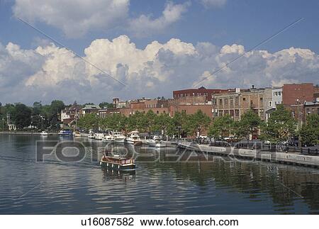 canal, Seneca Falls, NY, New York, Finger Lakes, A red, white and green houseboat cruises along the Cayuga-Seneca Canal in Seneca Falls. View Large Photo Image Stock Image - canal, Seneca Falls, NY, New York, Finger Lakes, A red, white and green houseboat cruises along the Cayuga-Seneca Canal in Seneca Falls.. Fotosearch