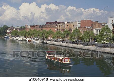 canal, Seneca Falls, NY, New York, Finger Lakes, A red, white and green houseboat cruises along the Cayuga-Seneca Canal in Seneca Falls. View Large Photo Image Stock Photograph - canal, Seneca Falls, NY, New York, Finger Lakes, A red, white and green houseboat cruises along the Cayuga-Seneca Canal in Seneca Falls.. Fotosearch