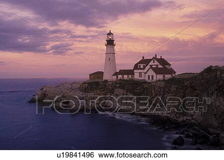 Stock Photograph -  Cape Elizabeth, ME, Maine, Portland Headlight along the rocky coastline of the Atlantic Ocean at sunset.. Fotosearch
