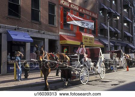 Stock Image -  carriage ride, Boston, MA, Massachusetts, Horse-drawn carriage along the street at Quincy Market in downtown Boston.. Fotosearch