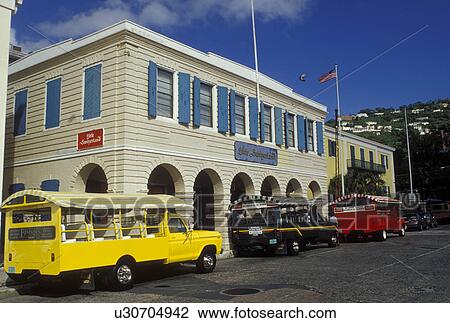 Stock Image -  Charlotte Amalie, St. Thomas, U. S. Virgin Islands, Caribbean, USVI, Shuttles parked outside Little Switzerland in downtown Charlotte Amalie on Saint Thomas Island.. Fotosearch