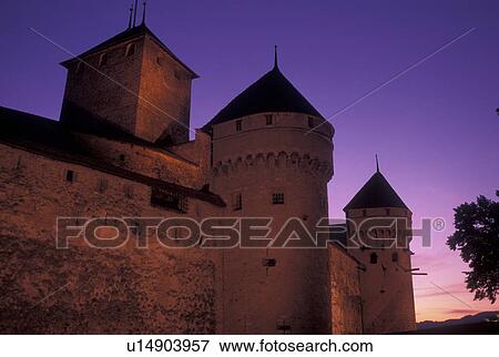 Stock Photo -  Chateau de Chillon, Switzerland, Lake Geneva, castle, sunset, Montreux, Vaud, Chateau de Chillon an 13th century fortress illuminated at sunset along the lakeshore of Lac Leman in the Canton of Vaud. . Fotosearch