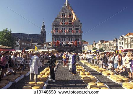 cheese market, Holland, Gouda, Netherlands, Zuid-Holland, Europe, Men testing cheese at the Cheese Market outside Town Hall on Cheese Market Day in downtown Gouda. View Large Photo Image Stock Photo - cheese market, Holland, Gouda, Netherlands, Zuid-Holland, Europe, Men testing cheese at the Cheese Market outside Town Hall on Cheese Market Day in downtown Gouda.. Fotosearch