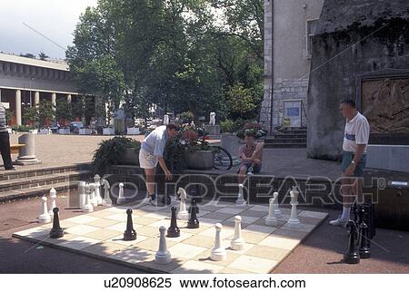 Stock Photography -  chess, France, Aix-Les-Bains, Savoie, Rhone-Alpes, Europe, Men playing Chess on a large Chess Board with large Chess pieces in a public park in the spa resort town of Aix-les-Bains.. Fotosearch