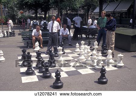 chess, game, Geneva, Switzerland, Men playing a game of chess on a giant chessboard at the Promenade des Bastions in the city of Geneva. View Large Photo Image Stock Image - chess, game, Geneva, Switzerland, Men playing a game of chess on a giant chessboard at the Promenade des Bastions in the city of Geneva.. Fotosearch