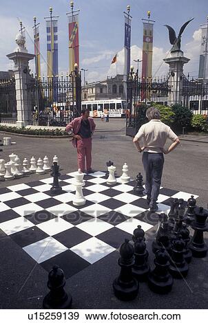 chess, game, Geneva, Switzerland, Men playing a game of chess on a giant chessboard at the Promenade des Bastions in the city of Geneva. View Large Photo Image Stock Photo - chess, game, Geneva, Switzerland, Men playing a game of chess on a giant chessboard at the Promenade des Bastions in the city of Geneva.. Fotosearch
