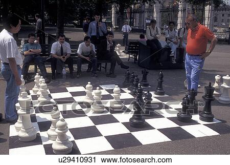chess, game, Switzerland, Geneva, Men playing a game of chess on a giant chessboard at the Promenade des Bastions in the city of Geneva. View Large Photo Image Stock Image - chess, game, Switzerland, Geneva, Men playing a game of chess on a giant chessboard at the Promenade des Bastions in the city of Geneva.. Fotosearch
