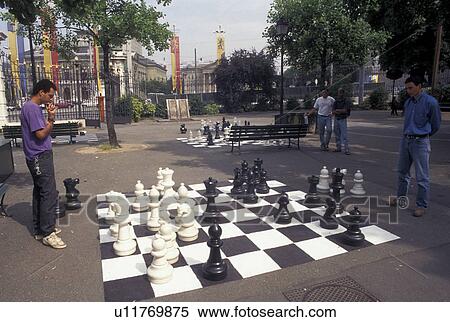 chess, game, Switzerland, Geneva, Men playing a game of chess on a giant chessboard at the Promenade des Bastions in the city of Geneva. View Large Photo Image Stock Photography - chess, game, Switzerland, Geneva, Men playing a game of chess on a giant chessboard at the Promenade des Bastions in the city of Geneva.. Fotosearch
