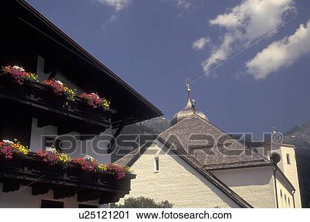 church, Austria, Tirol, Vorarlberg, St. Anton am Arlberg, Arlberg Region, Balconies on a chalet decorated with colorful flowers in the scenic alpine resort village of St. Anton am Arlberg in the Austrian Alps. View Large Photo Image Stock Image - church, Austria, Tirol, Vorarlberg, St. Anton am Arlberg, Arlberg Region, Balconies on a chalet decorated with colorful flowers in the scenic alpine resort village of St. Anton am Arlberg in the Austrian Alps.. Fotosearch