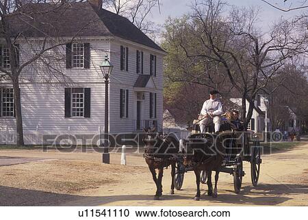 Colonial Williamsburg, VA, horse-drawn carriage, Williamsburg, Virginia, A team of horses pulling an open carriage carries tourists through the 18th century village of Colonial Williamsburg in Colonial Williamsburg Historic Area. View Large Photo Image Stock Image - Colonial Williamsburg, VA, horse-drawn carriage, Williamsburg, Virginia, A team of horses pulling an open carriage carries tourists through the 18th century village of Colonial Williamsburg in Colonial Williamsburg Historic Area.. Fotosearch