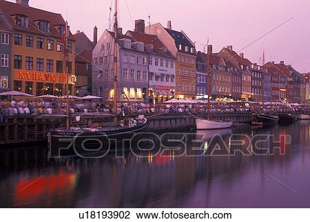 Copenhagen, Denmark, canal, Scandinavia, Sjaelland, Europe, Crowd of people along Nyhavn (New Harbor) in the scenic city of Copenhagen in the evening. Boats docked along the canal. View Large Photo Image Stock Image - Copenhagen, Denmark, canal, Scandinavia, Sjaelland, Europe, Crowd of people along Nyhavn (New Harbor) in the scenic city of Copenhagen in the evening. Boats docked along the canal.. Fotosearch