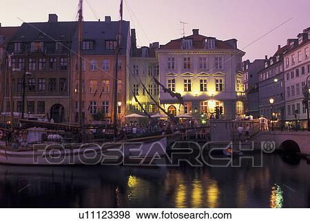Copenhagen, Denmark, canal, Scandinavia, Sjaelland, Europe, Boats docked along Nyhavn (New Harbor) in the scenic city of Copenhagen in the evening. View Large Photo Image Stock Photo - Copenhagen, Denmark, canal, Scandinavia, Sjaelland, Europe, Boats docked along Nyhavn (New Harbor) in the scenic city of Copenhagen in the evening. . Fotosearch
