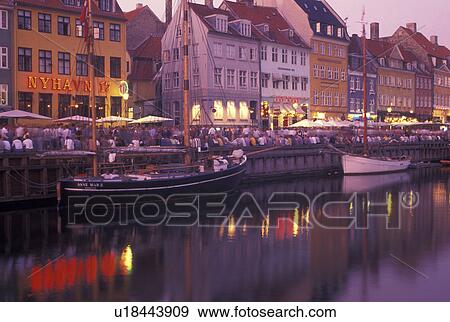 Copenhagen, Denmark, canal, Scandinavia, Sjaelland, Europe, Crowd of people along Nyhavn (New Harbor) in the scenic city of Copenhagen in the evening. Boats docked along the canal. View Large Photo Image Stock Photo - Copenhagen, Denmark, canal, Scandinavia, Sjaelland, Europe, Crowd of people along Nyhavn (New Harbor) in the scenic city of Copenhagen in the evening. Boats docked along the canal.. Fotosearch