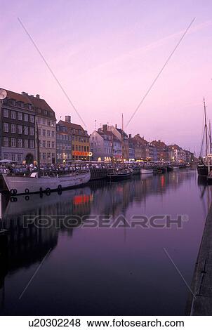 Copenhagen, Denmark, canal, Scandinavia, Sjaelland, Europe, Boats docked along Nyhavn (New Harbor) in the scenic city of Copenhagen in the evening. View Large Photo Image Stock Photo - Copenhagen, Denmark, canal, Scandinavia, Sjaelland, Europe, Boats docked along Nyhavn (New Harbor) in the scenic city of Copenhagen in the evening. . Fotosearch
