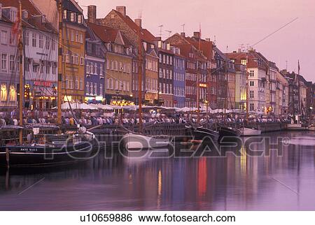 Copenhagen, Denmark, canal, Scandinavia, Sjaelland, Europe, Crowd of people along Nyhavn (New Harbor) in the scenic city of Copenhagen in the evening. Boats docked along the canal. View Large Photo Image Stock Photograph - Copenhagen, Denmark, canal, Scandinavia, Sjaelland, Europe, Crowd of people along Nyhavn (New Harbor) in the scenic city of Copenhagen in the evening. Boats docked along the canal.. Fotosearch