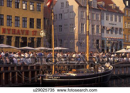 Stock Photography -  Copenhagen, Denmark, canal, Scandinavia, Sjaelland, Europe, Crowds of people along Nyhavn (New Harbor) in the scenic city of Copenhagen. Fotosearch