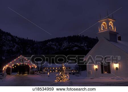 Stock Photo -  covered bridge, church, NH, New Hampshire, Stark, Christmas lights decorate the Stark Union Church and covered bridge in the evening in winter.. Fotosearch