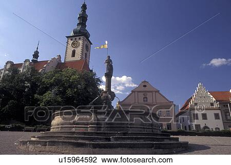 Stock Image -  Czech Republic, Tabor, Southern Bohemia, Church and fountain in the central square in the town of Tabor.. Fotosearch