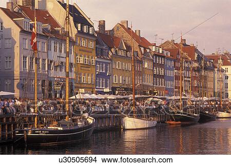Picture -  Denmark, Copenhagen, canal, Scandinavia, Sjaelland, Europe, Crowds of people along Nyhavn (New Harbor) in the scenic city of Copenhagen. Fotosearch