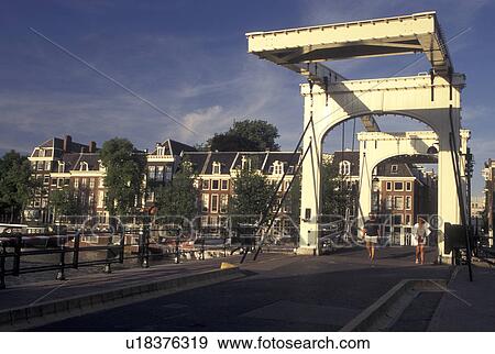 drawbridge, Amsterdam, Holland, Netherlands, Noord-Holland, Europe, Skinny Drawbridge crosses a canal in Amsterdam. View Large Photo Image Stock Photo - drawbridge, Amsterdam, Holland, Netherlands, Noord-Holland, Europe, Skinny Drawbridge crosses a canal in Amsterdam.. Fotosearch