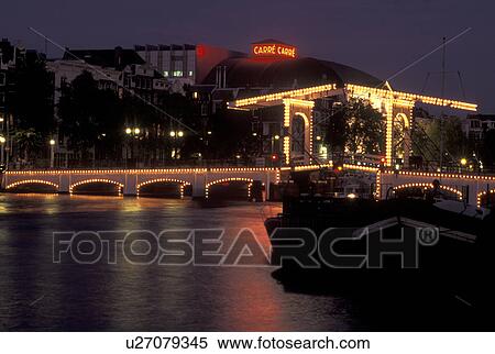 Stock Photography -  drawbridge, Amsterdam, Netherlands, Holland, Noord-Holland, Europe, Skinny Drawbridge illuminated at night on a canal in Amsterdam.. Fotosearch