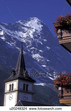 Eiger, Switzerland, Grindenwald, Berne, Bern, Bernese Alps, church steeple, balcony with flowers, mountain, Bernese Oberland. View Large Photo Image Picture - Eiger, Switzerland, Grindenwald, Berne, Bern, Bernese Alps, church steeple, balcony with flowers, mountain, Bernese Oberland.. Fotosearch