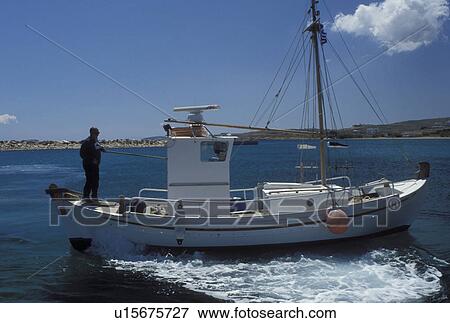 fishing boats, Paros, Greek Islands, Cyclades, Greece, Europe, Fishing boat cruises slowly in the harbor of Piso Livadi on Paros Island on the Aegean Sea. View Large Photo Image Stock Photo - fishing boats, Paros, Greek Islands, Cyclades, Greece, Europe, Fishing boat cruises slowly in the harbor of Piso Livadi on Paros Island on the Aegean Sea.. Fotosearch