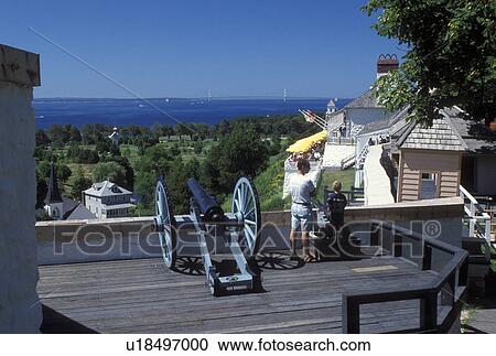 Stock Image -  Fort Mackinac, Mackinac Island, MI, Lake Huron, Michigan, Mackinac Island State Park, Cannon displayed at scenic overlook of Mackinac Island from Fort Mackinac on Lake Huron.. Fotosearch