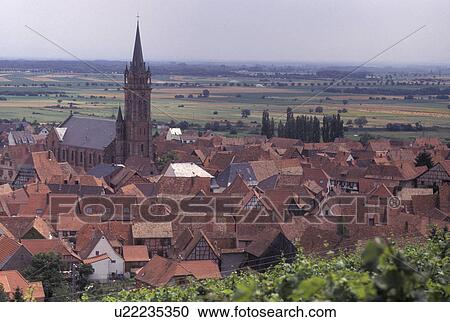 Stock Image -  France, Alsace, Dambach-la-Ville, Bas-Rhin, Europe, wine region, Picturesque village of Dambach-la-Ville surrounded by vineyards in the wine region of Alsace.. Fotosearch