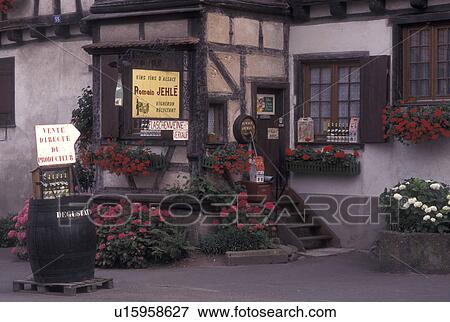 Stock Photo -  France, Alsace, Dambach-la-Ville, Bas-Rhin, Europe, wine region, Entrance to a Wine House decorated with flowers in the village of Dambach-la-Ville in the wine region of Alsace.. Fotosearch