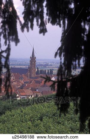 Stock Photo -  France, Alsace, Dambach-la-Ville, Bas-Rhin, Europe, wine region, Picturesque village of Dambach-la-Ville surrounded by vineyards in the wine region of Alsace.. Fotosearch
