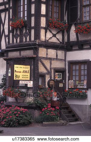 Stock Photography -  France, Alsace, Dambach-la-Ville, Bas-Rhin, Europe, wine region, Entrance to a Wine House decorated with flowers in the village of Dambach-la-Ville in the wine region of Alsace.. Fotosearch
