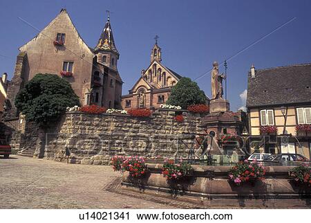 France, Alsace, Eguisheim, Haut-Rhin, Europe, wine region, Cathedral and fountain decorated with flowers in the picturesque village of Equisheim in the wine region of Alsace. View Large Photo Image Stock Image - France, Alsace, Eguisheim, Haut-Rhin, Europe, wine region, Cathedral and fountain decorated with flowers in the picturesque village of Equisheim in the wine region of Alsace.. Fotosearch