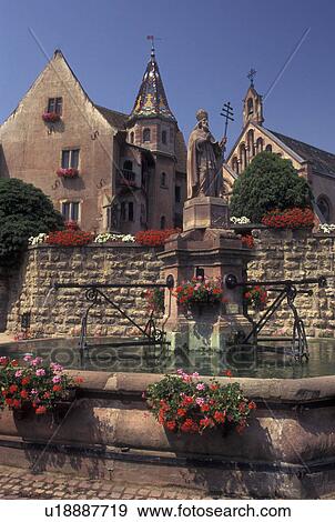 France, Alsace, Eguisheim, Haut-Rhin, Europe, wine region, Cathedral and fountain decorated with flowers in the picturesque village of Equisheim in the wine region of Alsace. View Large Photo Image Stock Photo - France, Alsace, Eguisheim, Haut-Rhin, Europe, wine region, Cathedral and fountain decorated with flowers in the picturesque village of Equisheim in the wine region of Alsace.. Fotosearch