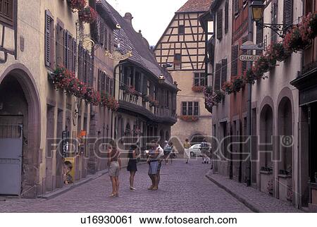 France, Alsace, Kaysersberg, Haut-Rhin, Europe, wine region, People shopping along the narrow cobblestone pedestrian streets surrounded by half-timbered buildings in the picturesque village of Kaysersberg in the wine region of Alsace. View Large Photo Image Stock Image - France, Alsace, Kaysersberg, Haut-Rhin, Europe, wine region, People shopping along the narrow cobblestone pedestrian streets surrounded by half-timbered buildings in the picturesque village of Kaysersberg in the wine region of Alsace.. Fotosearch