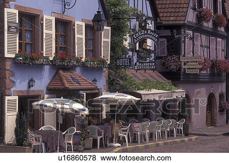 France, Alsace, Kaysersberg, Haut-Rhin, Europe, wine region, Outdoor cafT along a narrow cobblestone pedestrian street surrounded by half-timbered buildings in the picturesque village of Kaysersberg in the wine region of Alsace. View Large Photo Image Stock Photo - France, Alsace, Kaysersberg, Haut-Rhin, Europe, wine region, Outdoor cafT along a narrow cobblestone pedestrian street surrounded by half-timbered buildings in the picturesque village of Kaysersberg in the wine region of Alsace.. Fotosearch