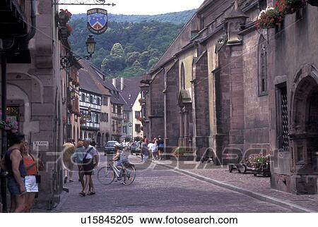 France, Alsace, Kaysersberg, Haut-Rhin, Europe, wine region, People walking along the narrow cobblestone pedestrian streets surrounded by half-timbered buildings in the picturesque village of Kaysersberg in the wine region of Alsace. View Large Photo Image Stock Photography - France, Alsace, Kaysersberg, Haut-Rhin, Europe, wine region, People walking along the narrow cobblestone pedestrian streets surrounded by half-timbered buildings in the picturesque village of Kaysersberg in the wine region of Alsace.. Fotosearch