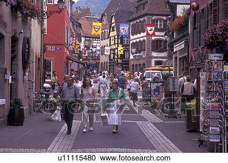France, Alsace, Ribeauville, Haut-Rhin, Europe, wine region, People walking along the narrow streets surrounded by half-timbered buildings in the picturesque village of Ribeauville in the wine region of Alsace. View Large Photo Image Stock Image - France, Alsace, Ribeauville, Haut-Rhin, Europe, wine region, People walking along the narrow streets surrounded by half-timbered buildings in the picturesque village of Ribeauville in the wine region of Alsace.. Fotosearch