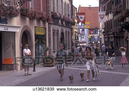 France, Alsace, Ribeauville, Haut-Rhin, Europe, wine region, People walking along the narrow streets surrounded by half-timbered buildings in the picturesque village of Ribeauville in the wine region of Alsace. View Large Photo Image Stock Photo - France, Alsace, Ribeauville, Haut-Rhin, Europe, wine region, People walking along the narrow streets surrounded by half-timbered buildings in the picturesque village of Ribeauville in the wine region of Alsace.. Fotosearch