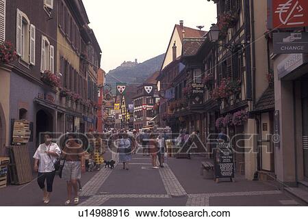 France, Alsace, Ribeauville, Haut-Rhin, Europe, wine region, People walking along the narrow streets surrounded by half-timbered buildings in the picturesque village of Ribeauville in the wine region of Alsace. View Large Photo Image Stock Photograph - France, Alsace, Ribeauville, Haut-Rhin, Europe, wine region, People walking along the narrow streets surrounded by half-timbered buildings in the picturesque village of Ribeauville in the wine region of Alsace.. Fotosearch