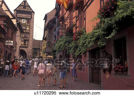France, Alsace, Riquerwihr, Haut-Rhin, Europe, wine region, People walking on the cobbled streets surrounded by half-timbered buildings in the picturesque village of Riquerwihr in the wine region of Alsace. View Large Photo Image Stock Photography - France, Alsace, Riquerwihr, Haut-Rhin, Europe, wine region, People walking on the cobbled streets surrounded by half-timbered buildings in the picturesque village of Riquerwihr in the wine region of Alsace.. Fotosearch